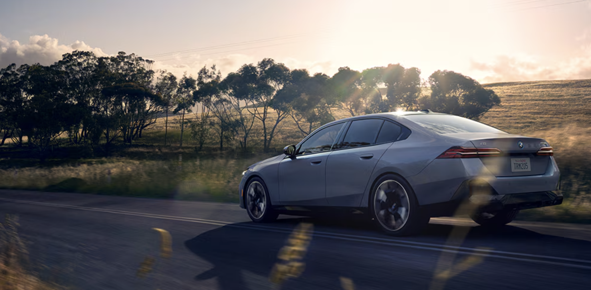 2024 BMW 5 Series Trim Comparison 2024 BMW 5 series driving at sunset