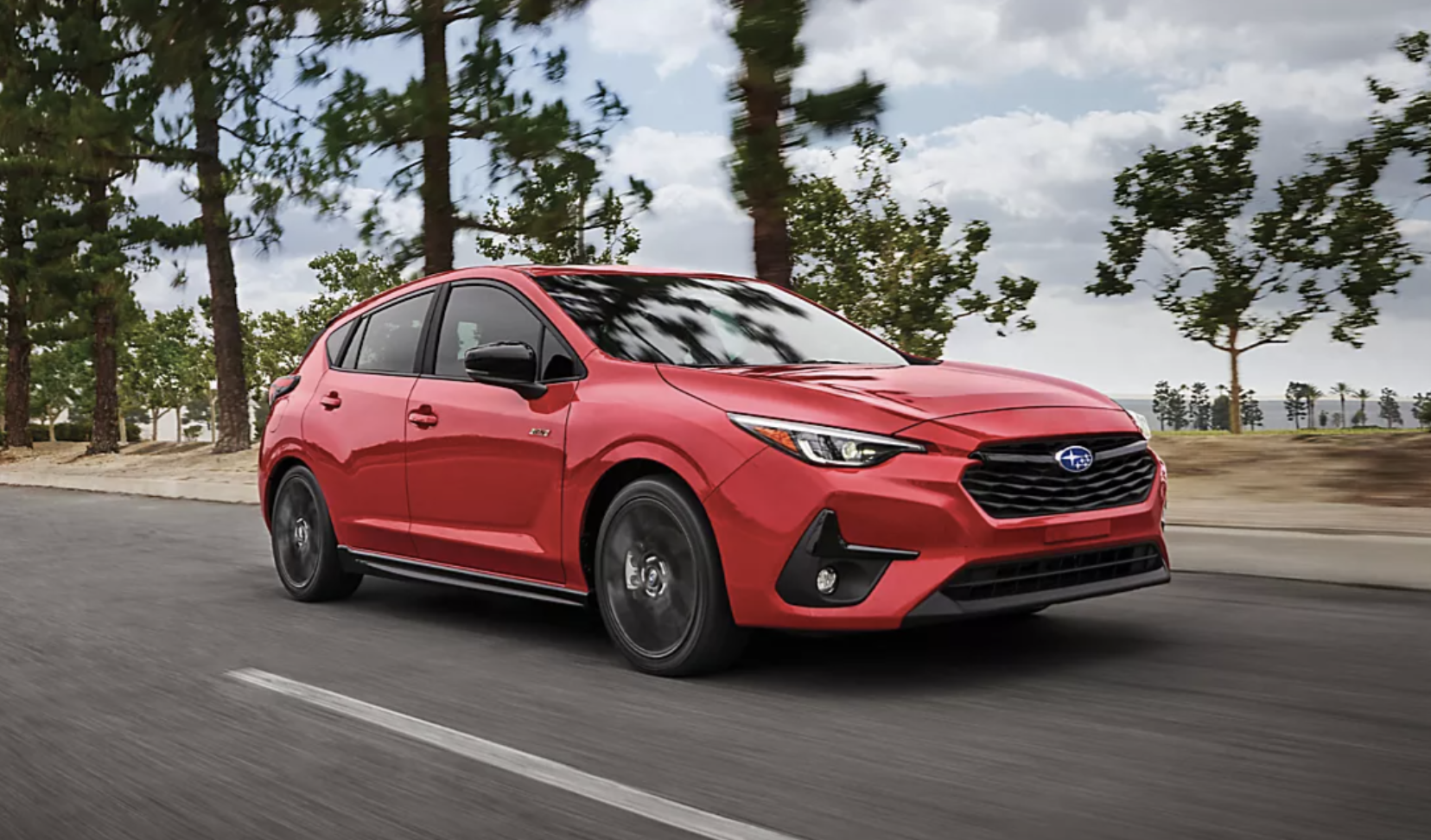 Red Subaru Impreza driving on the highway