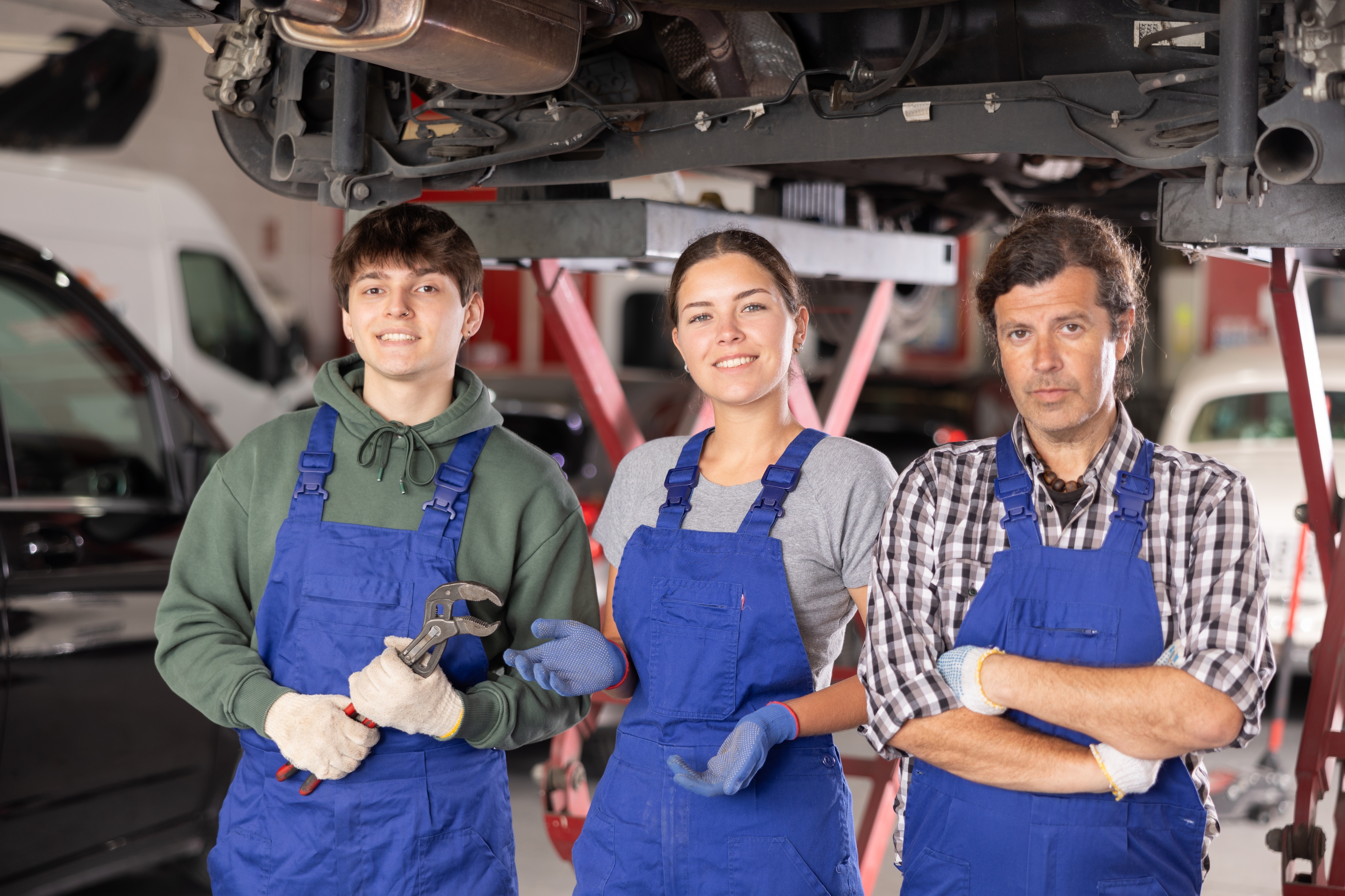 A trio of service technicians standing in a service center.