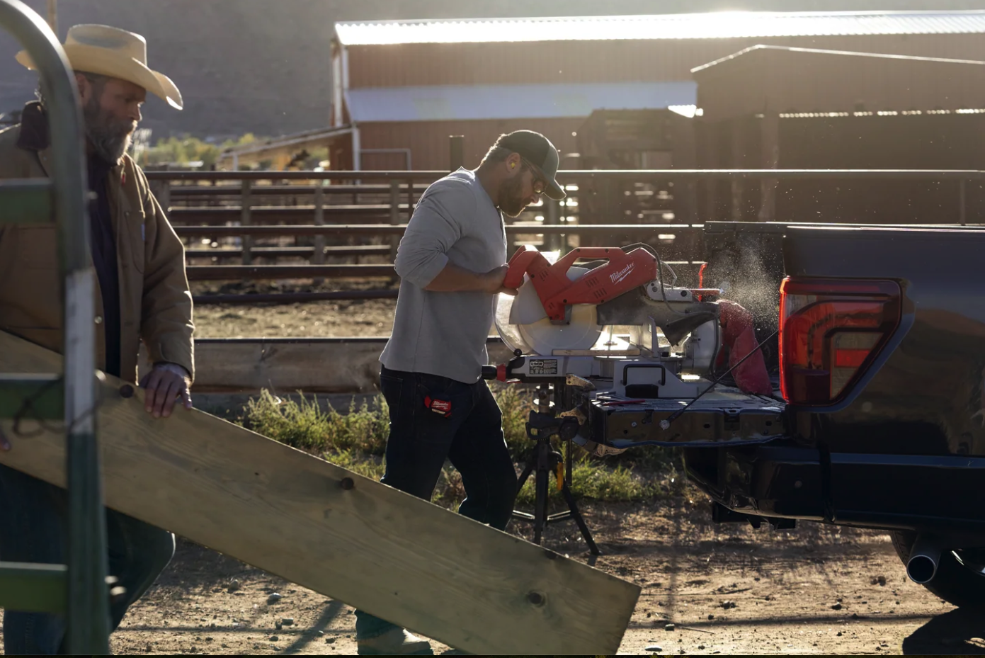 A person using a power saw via the 2024 Ford F-150 Pro Power Onboard feature