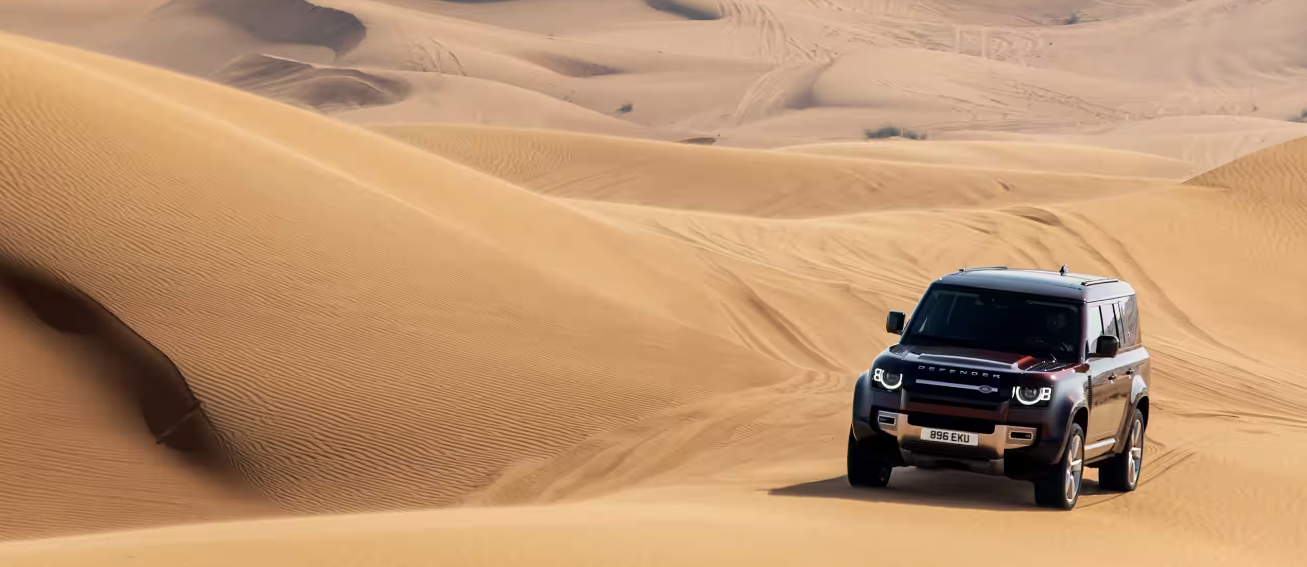 Defender 130 driving on sand dunes