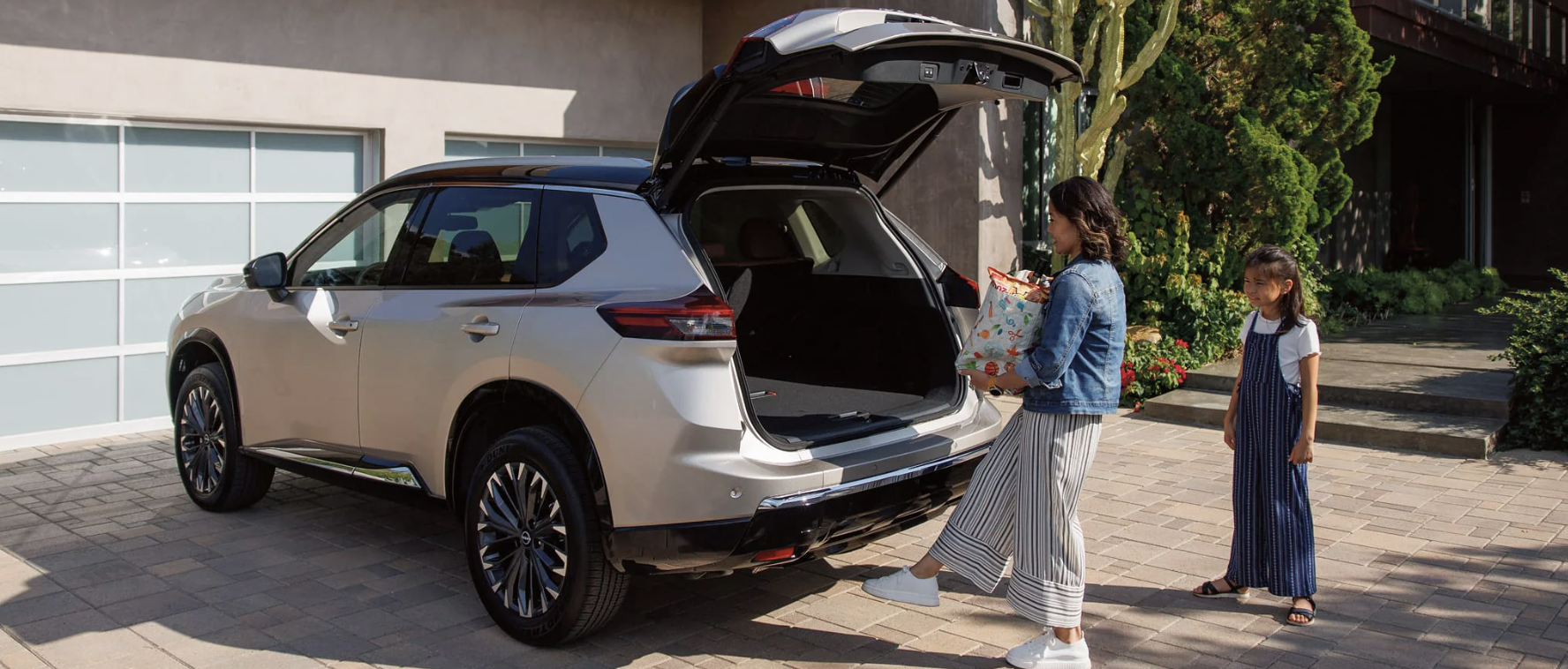 Family unpacking a new Nissan Rogue in Bloomfield, NJ
