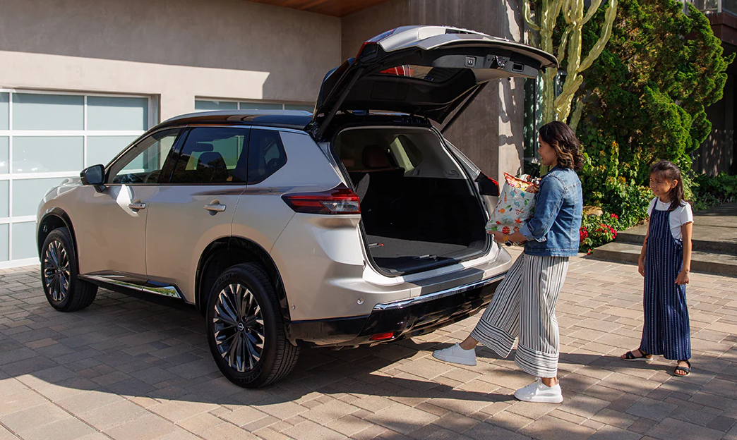 A woman opens the motion-activated liftgate on the 2024 Nissan Rogue with her foot